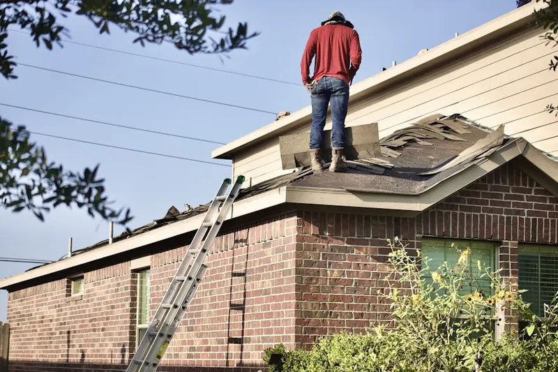 Professional roofer working on a residential roof in Broad Run